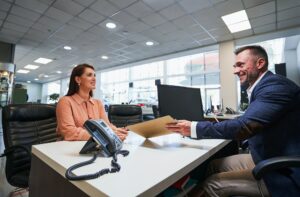 Friendly conversation in the car dealership office