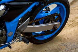 Rear wheel of motorcycle. Chain transmission. Beautiful blue moto.